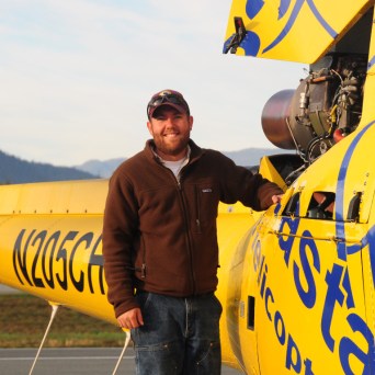 a man standing next to a plane