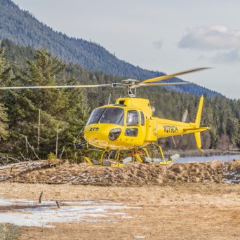 a helicopter parked on a dirt track
