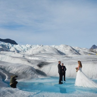 a man riding a snowboard down a snow covered mountain