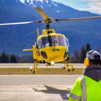 a group of people standing around a plane