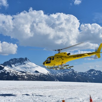 a person flying through the air on a snow covered mountain