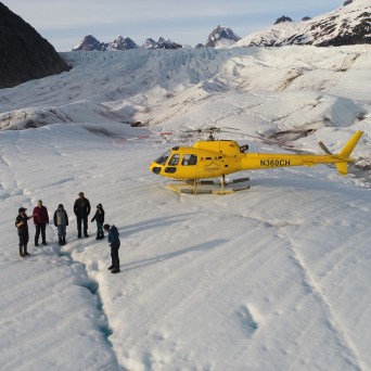 a group of people riding skis on top of a snow covered mountain