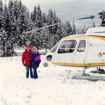 a couple of people that are standing in the snow