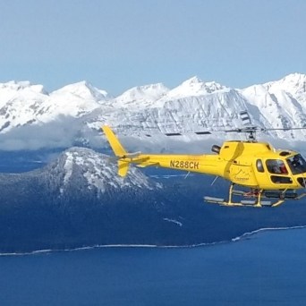 a plane flying over a snow covered mountain