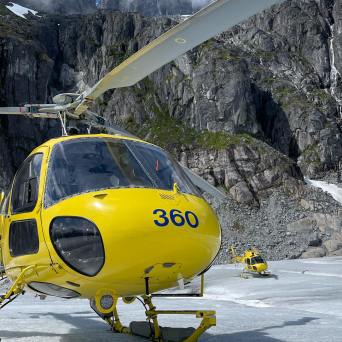 a small airplane sitting on top of a mountain