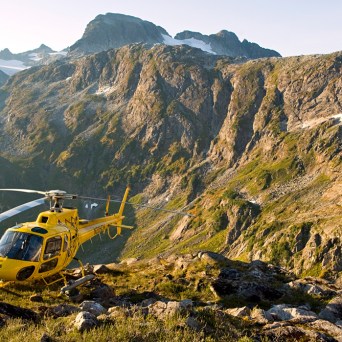 a plane sitting on top of a rocky mountain