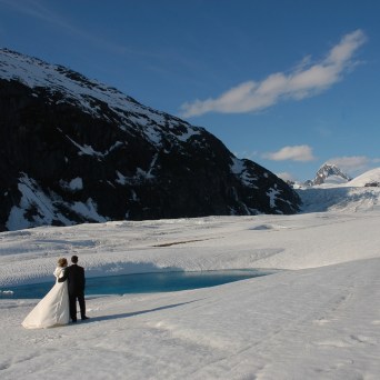 a person standing on top of a snow covered mountain