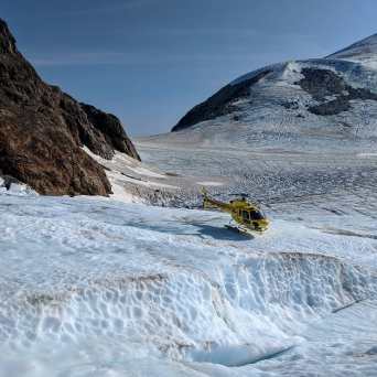 a man riding on top of a snow covered mountain