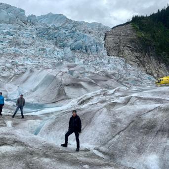 a group of people walking across a snow covered mountain